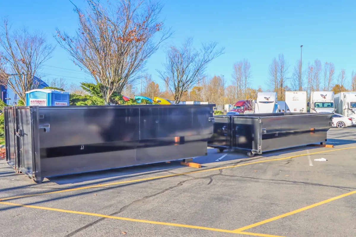 Professional dumpster rental service with roll-off container on residential driveway in Ralston